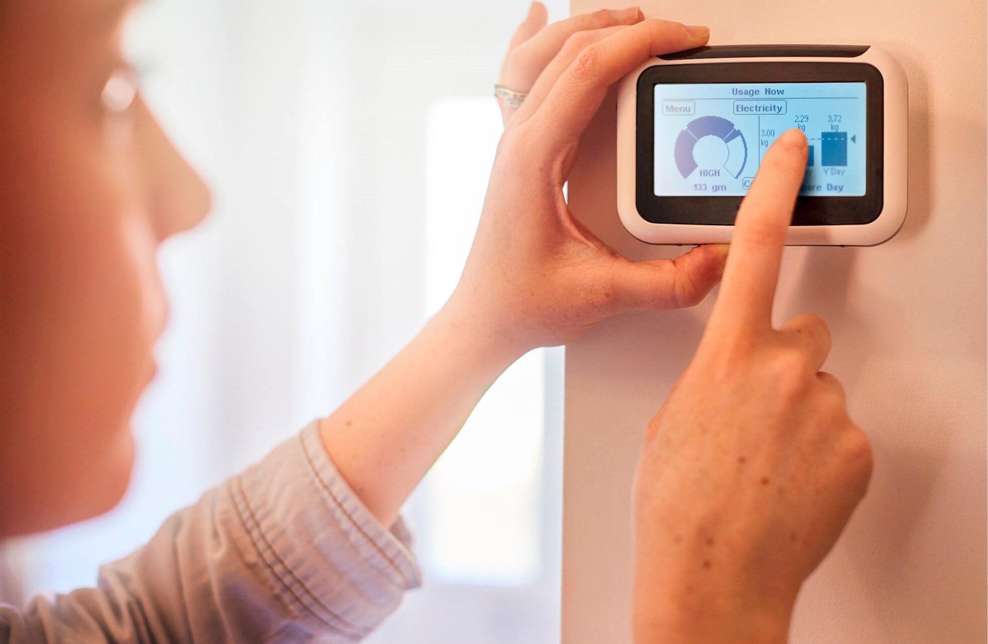 A woman checking an in-home display