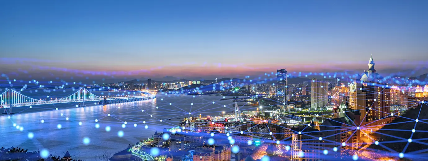 A photo of a city with super-imposed blue lines representing network connections.