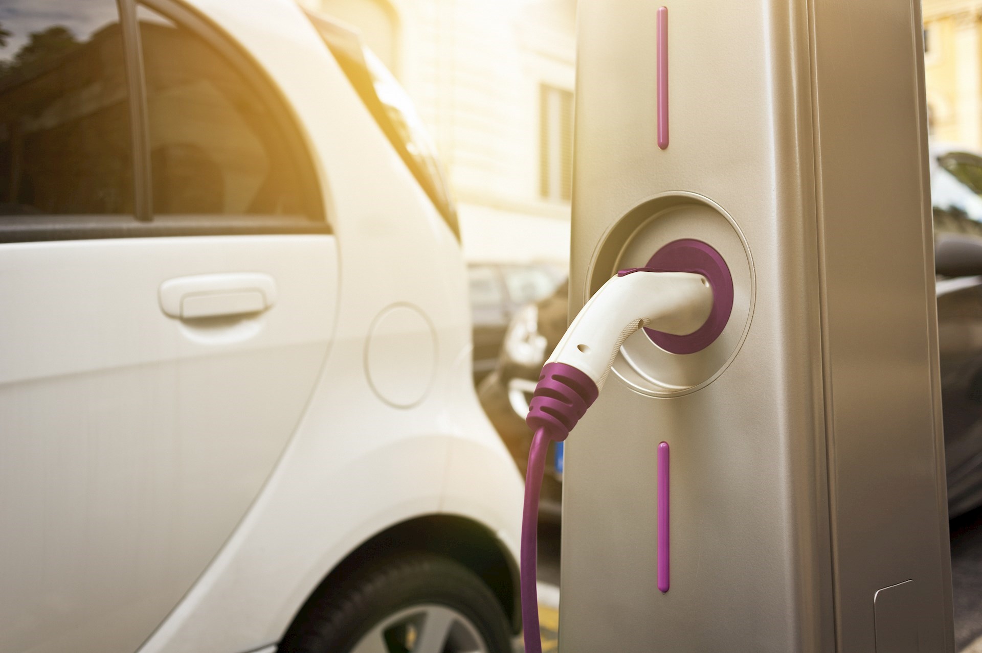 An electric vehicle plugged into a charger.