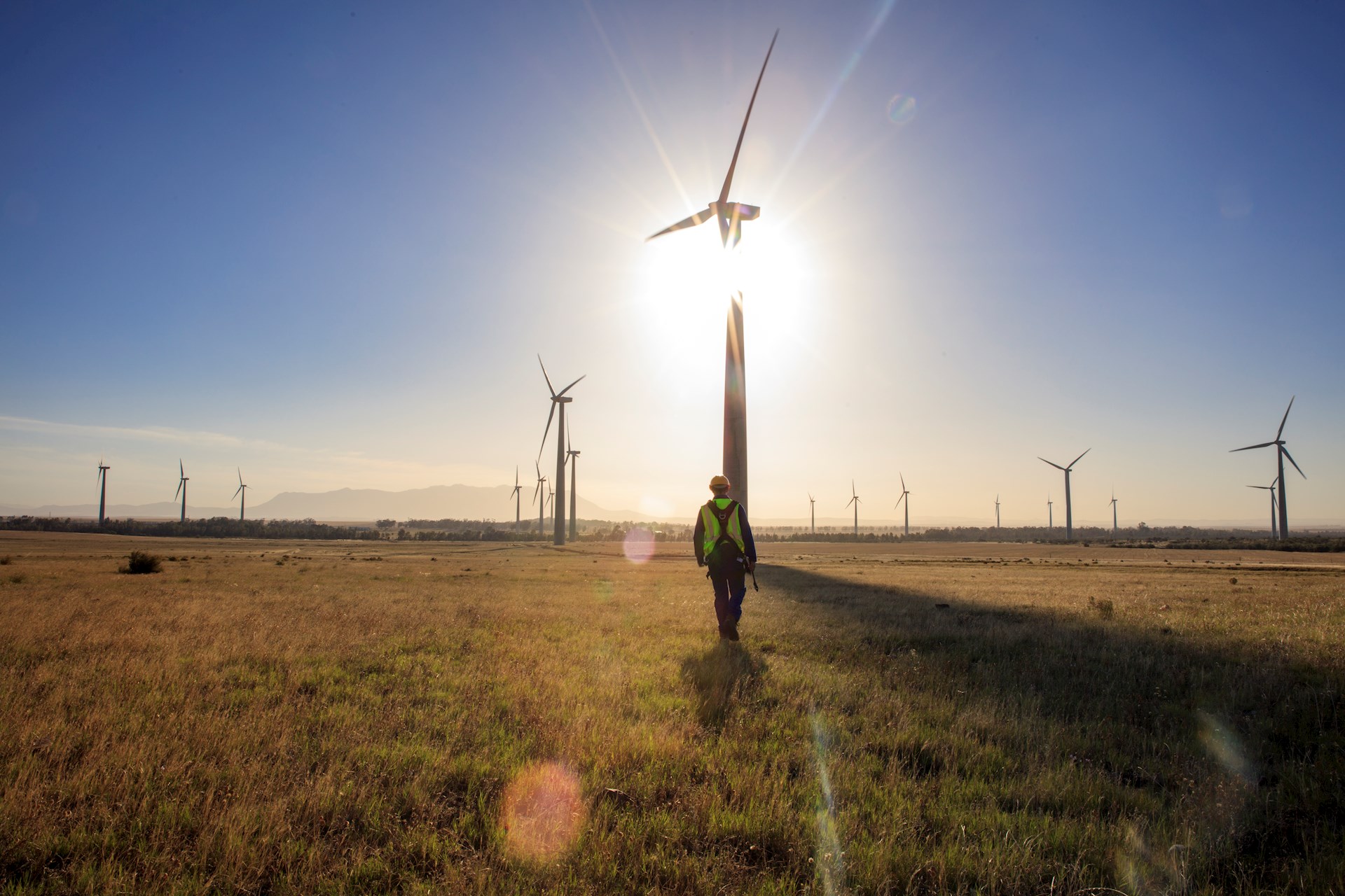Wind turbines spinning at sunset