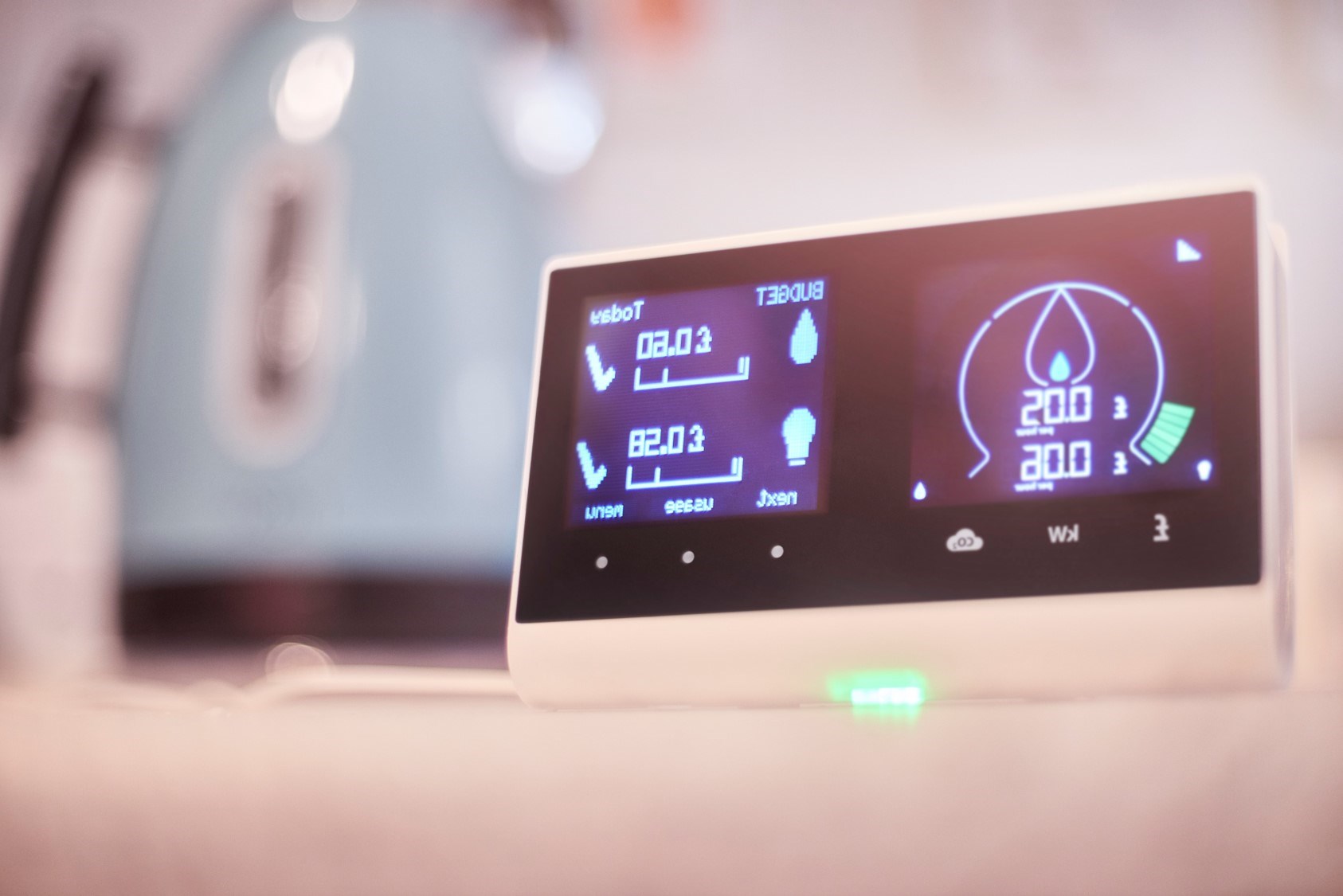 A photograph of a smart meter sat on a kitchen countertop.