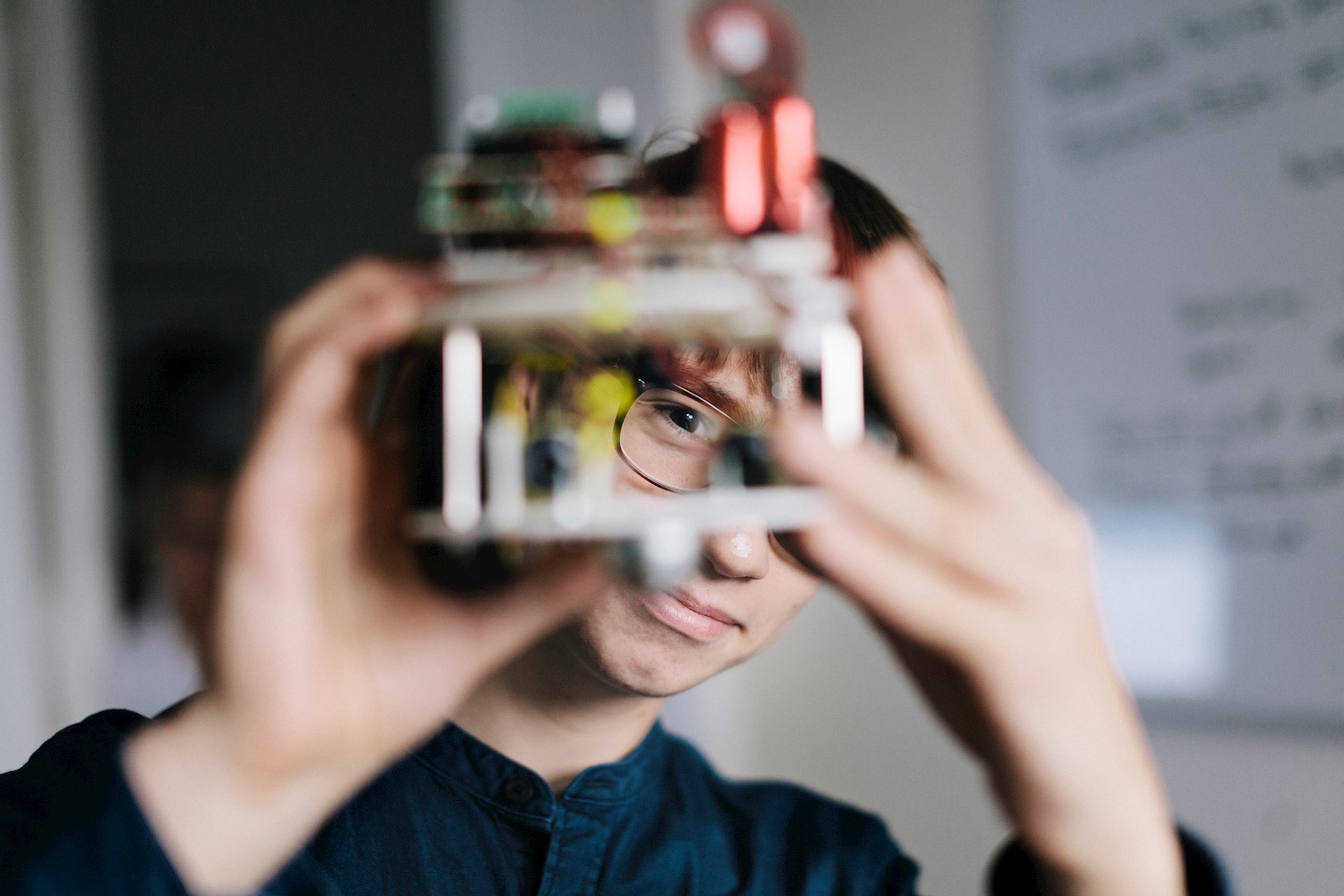 Man looking at electronic machinery