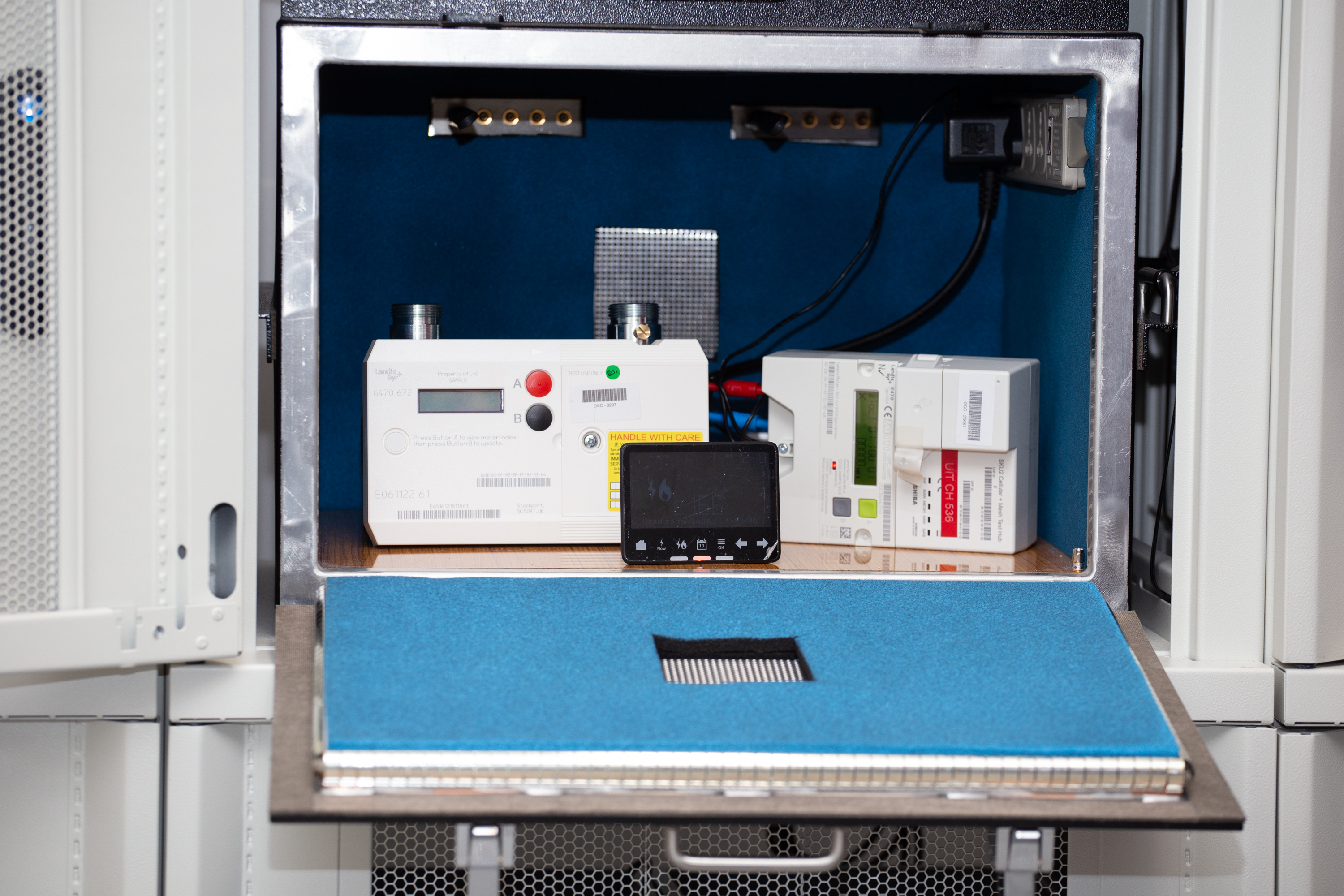 A smart meter and a communications hub in a testing cage
