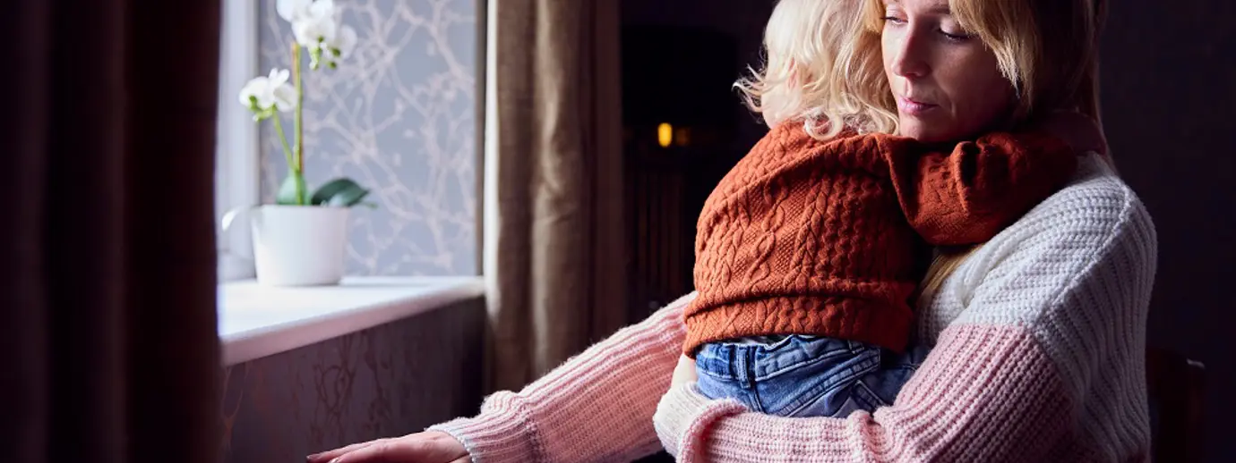 A mother and her child checking the temperature of a radiator