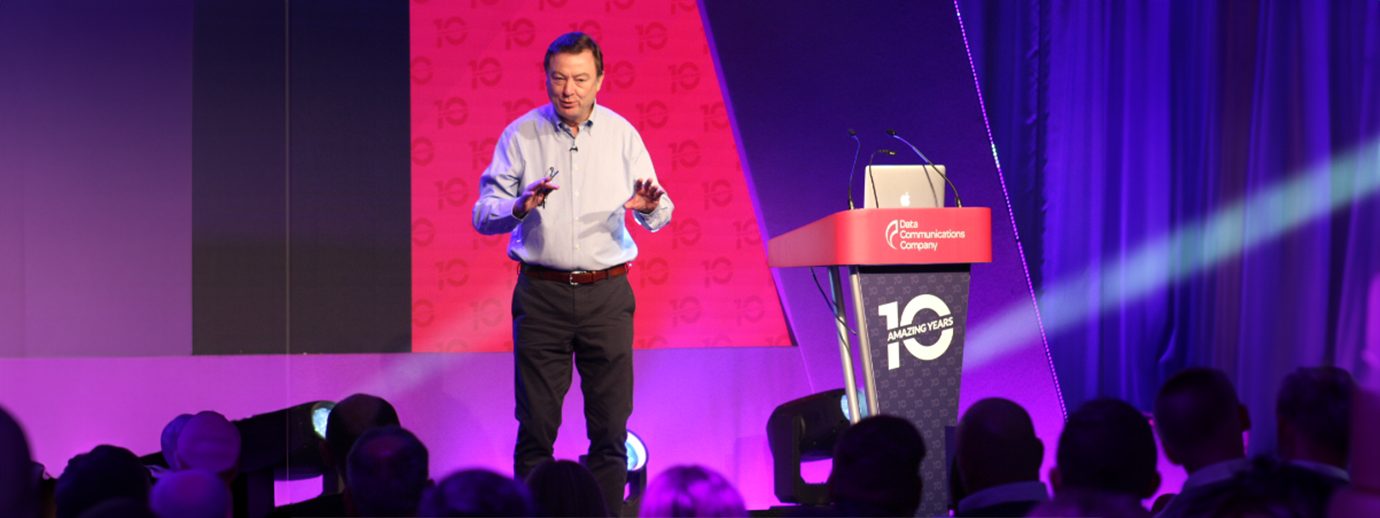 An image of Angus Flett speaking to a crowd at an event